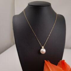 Gouden halsketting met parelhanger.